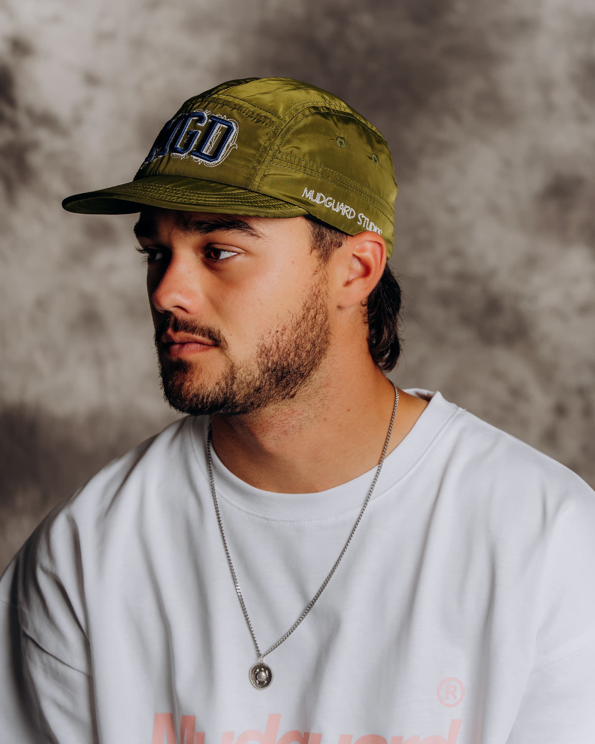 Olive six panel streetwear cap side view worn by model