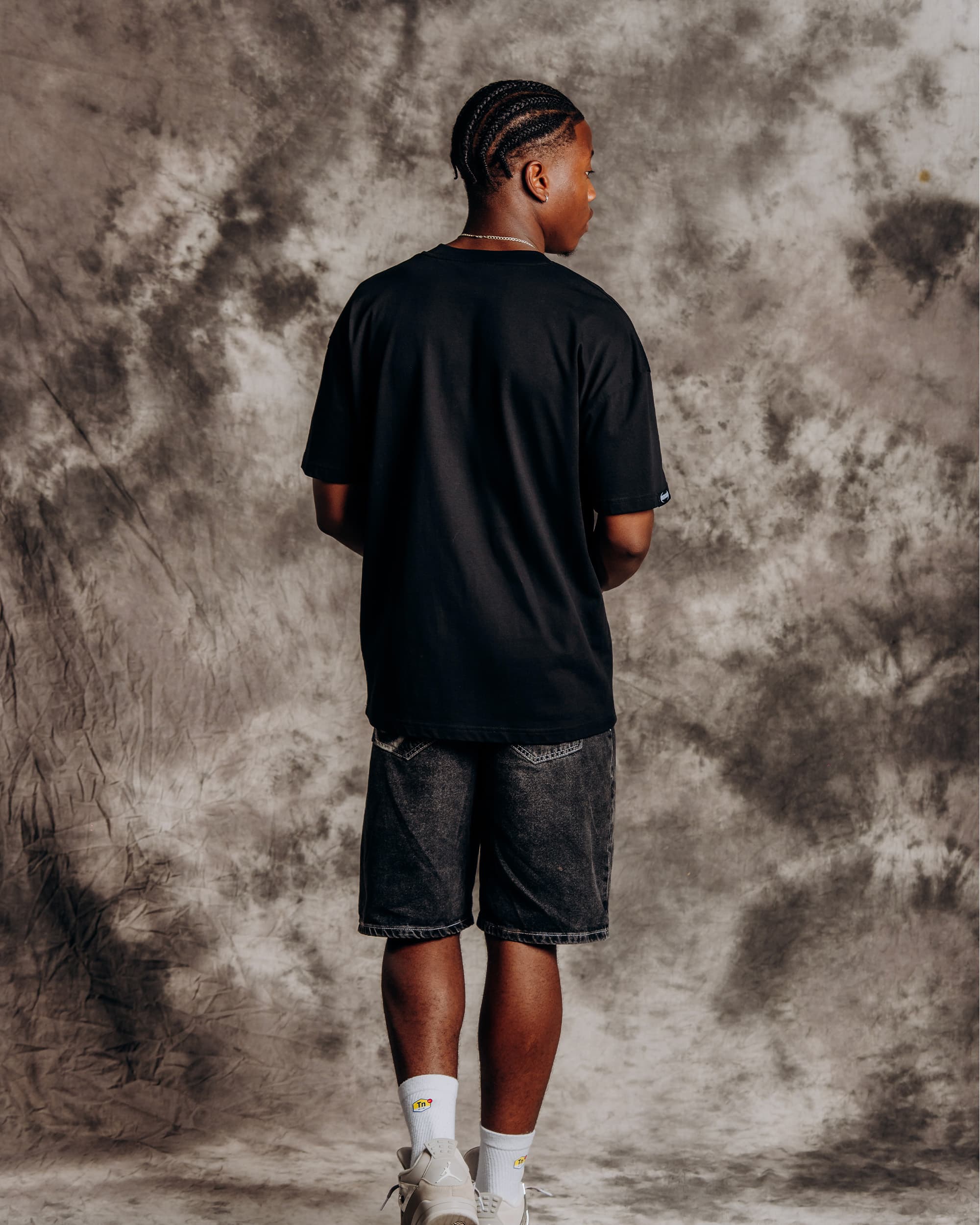 Oversized black graphic t-shirt model back view